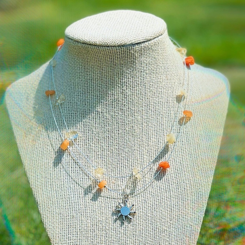 Floating crystal choker with sun charm